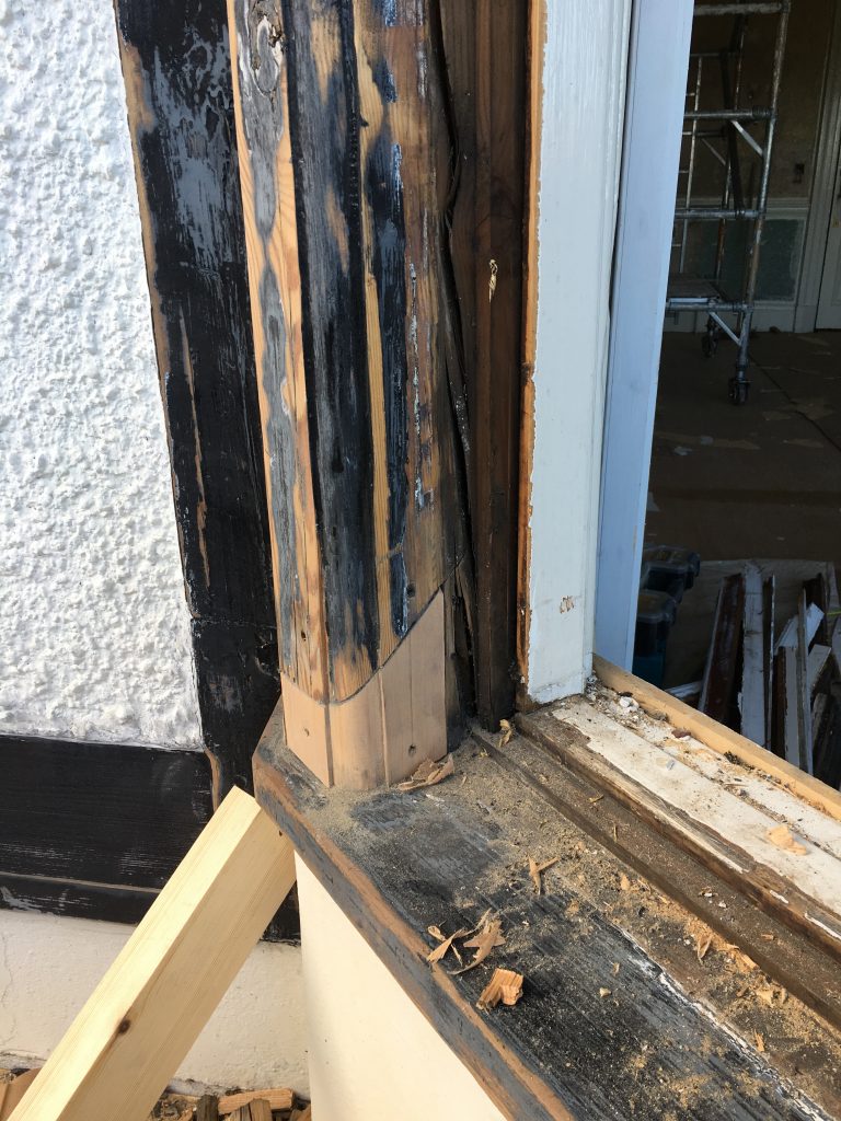 Decayed timber on a sash window case awaiting restoration